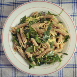 Vegan pasta with fresh dressing of rocket salad and mozzarella