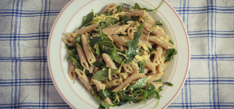 Vegan pasta with fresh dressing of rocket salad and mozzarella