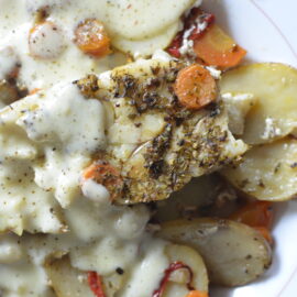 Oven baked fish and vegetables with white sauce