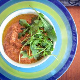 Mushrooms and tomato pureed soup with rocket salad