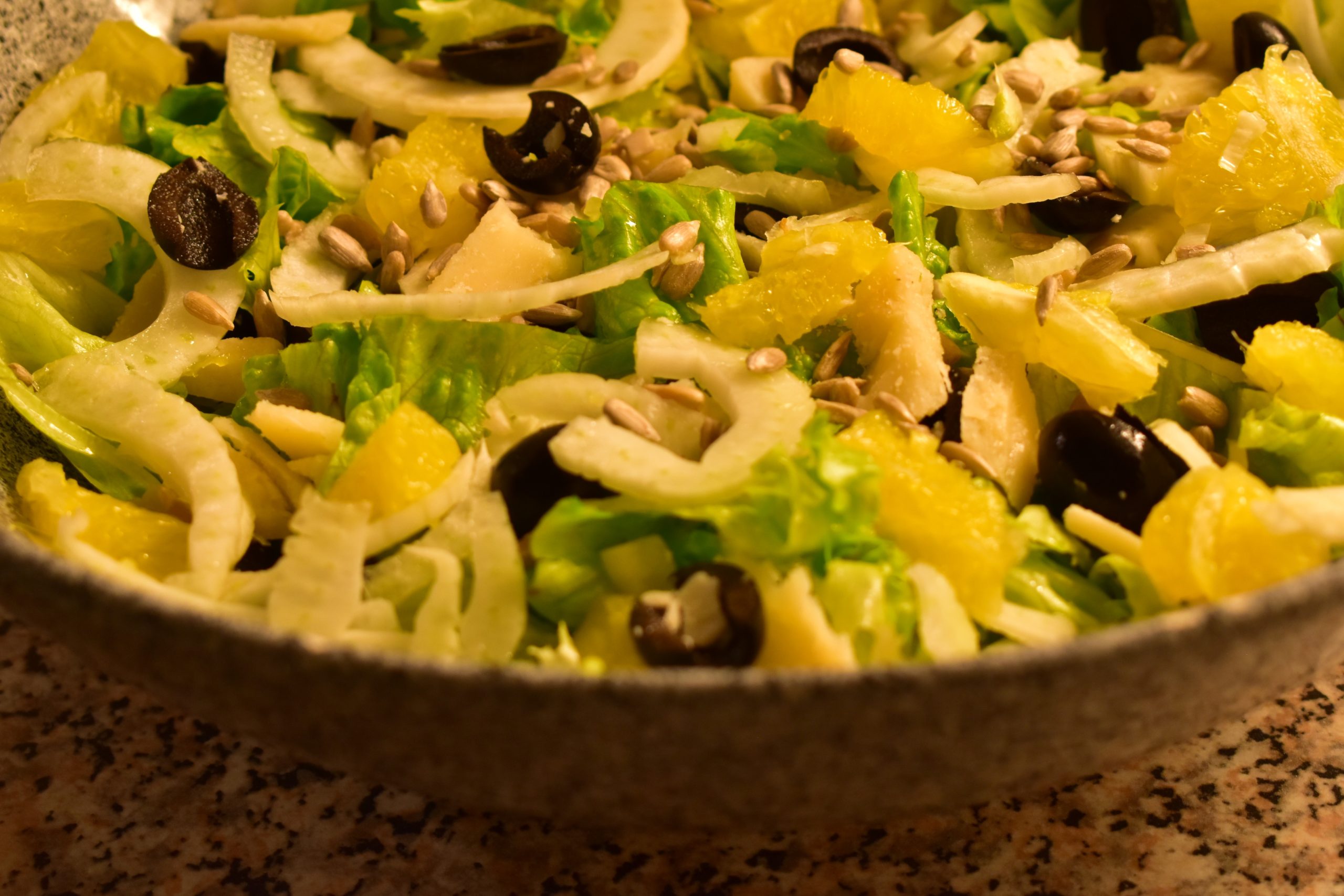 Lettuce with fennel, black olives, sunflower seeds, orange and Grana Padano